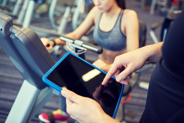 Canvas Print - close up of trainer hands with tablet pc in gym