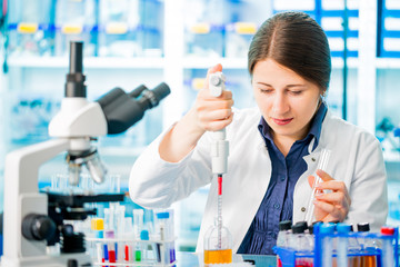 Wall Mural - laboratory assistant analyzing a blood sample