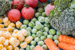 frozen vegetables: broccoli, cherry tomatoes, corn, pea, carrot on blue plate