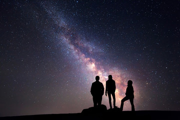 Wall Mural - Milky Way. Night sky and silhouette of a family