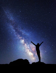 Wall Mural - Milky Way. Night sky with stars and silhouette of a woman