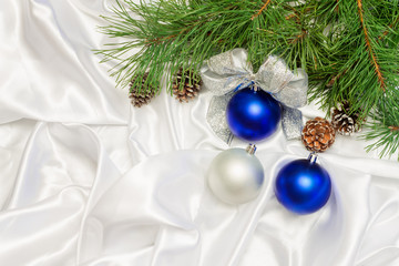 silver and blue Christmas balls with beads and pine branch on a 