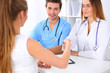 © rogerphoto - Male doctor and female patient shaking hands. Partnership, trust and medical ethics concept