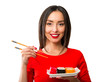 Young woman holding sushi with a chopsticks, isolated on white