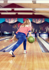 Sticker - happy young woman throwing ball in bowling club