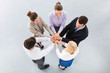 © pikselstock - Business people holding hands to form a circle