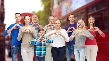 Canvas Print - people showing heart hand sign over london city