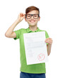 © Syda Productions - happy boy in eyeglasses holding school test result