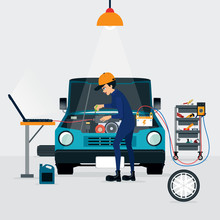 Auto Mechanic Repairing A Car With The Engine Running And The Computer.