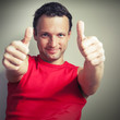 © evannovostro - Positive young smiling man shows thumbs up