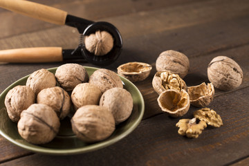Wall Mural - walnuts with nutcracker on a green plate