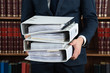 Lawyer Carrying Stack Of Ring Binders