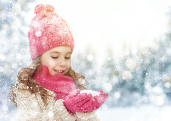 Wall Mural - girl playing on a winter walk