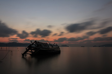 Wall Mural - Wreck ship on the beach in sunrise