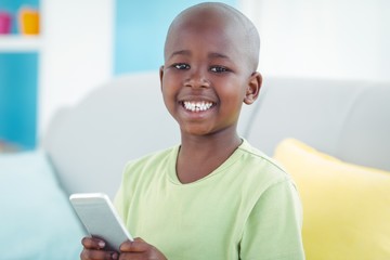 Wall Mural - Happy boy using a smartphone