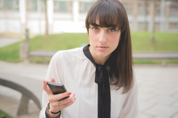 Wall Mural - Headshot of a young beautiful brown hair businesswoman seated on