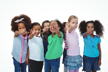 Wall Mural - Line of girls standing with hands pointing ahead