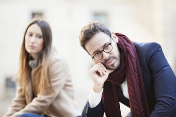 Portrait of young woman and man outdoor on street having relationship problems