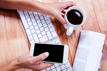 Poster - Businesswoman using her smartphone on desk