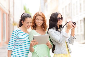 Canvas Print - smiling teenage girls with tablet pc and camera