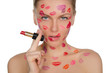 Charming woman with kisses on face in lipstick and lips