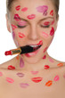 woman with kisses on face and lipstick in mouth