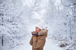 © stock.film - girl in warm clothes in the winter is snowy forest