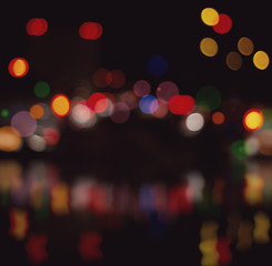 Wall Mural - blurred city lights with bokeh on water