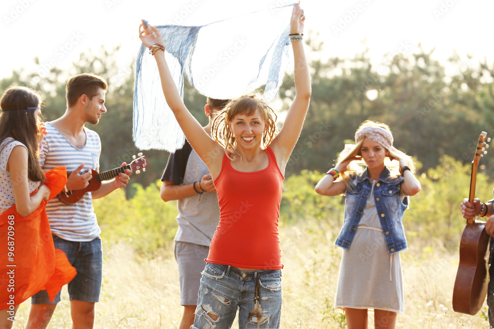 Joyful smiling friends having fun in the forest outdoors