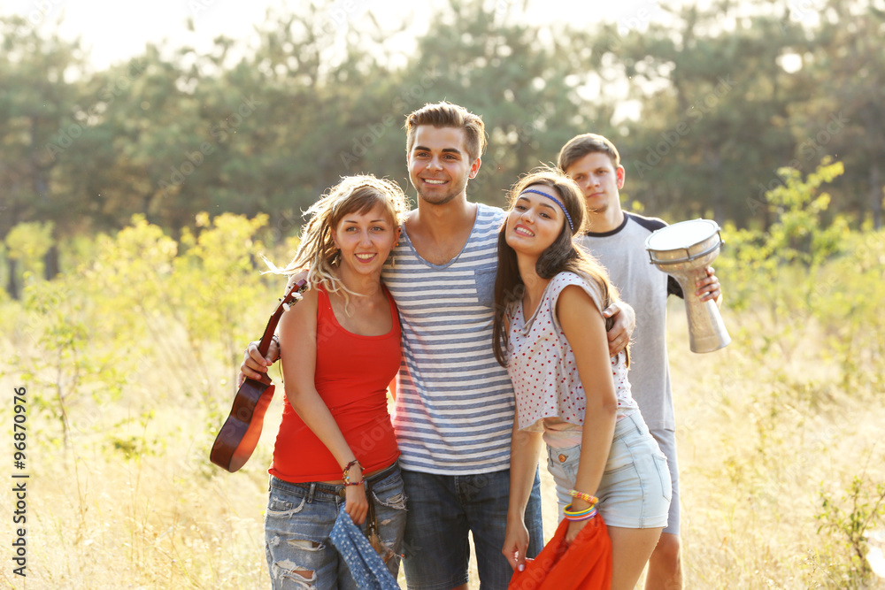 Smiling friends having fun in the forest outdoors