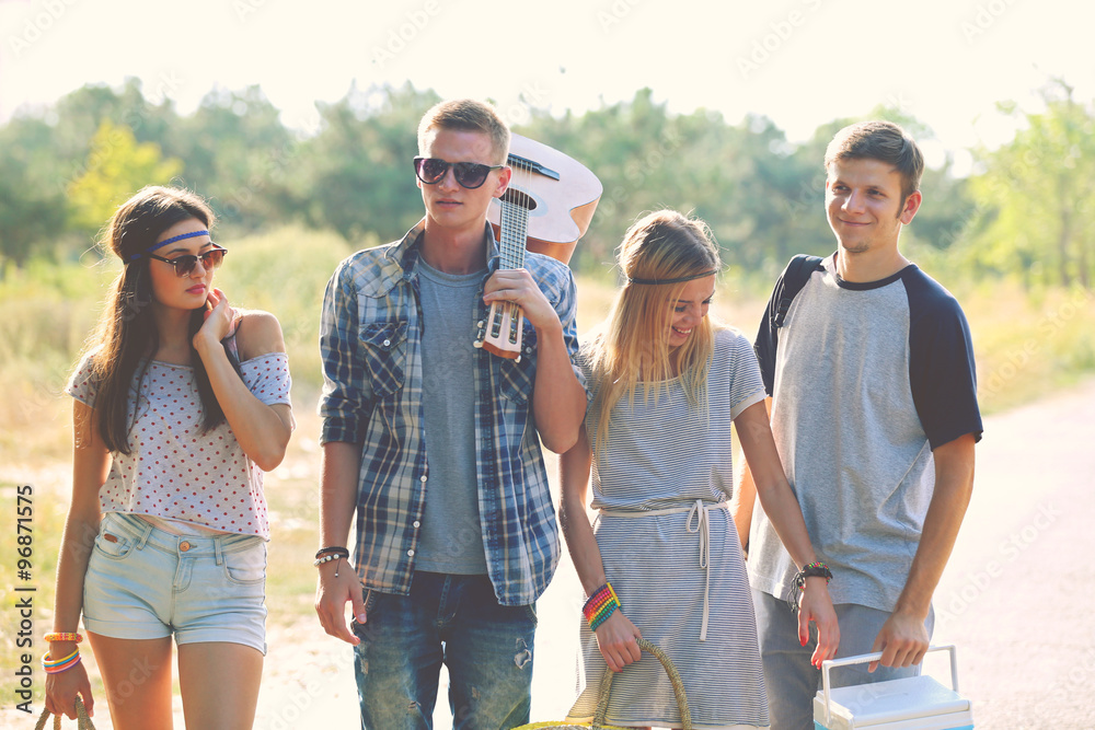 A group of young people standing on a road