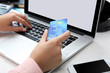 © Africa Studio - Concept for Internet shopping: hands with laptop and credit card