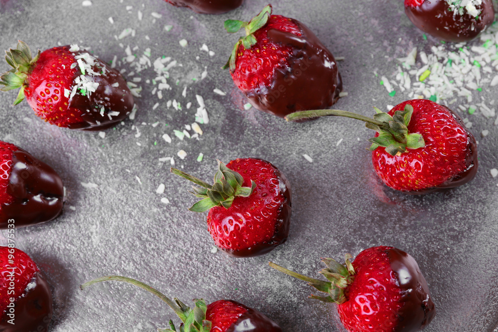 Delicious strawberries in chocolate on metallic background