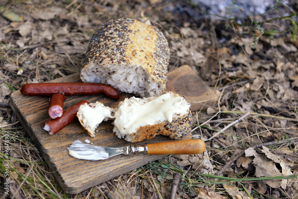 Grilled sausages on cutting board in the wood