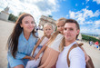 © travnikovstudio - Happy young family with map of city taking selfie background famous Louvre in Paris
