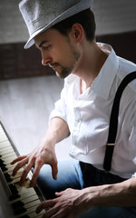 Poster - Profile of handsome young man in hat making piano music