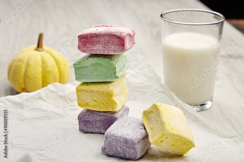 Fotografie, Obraz Set of marshmallows on craft paper with milk and small pumpkin o