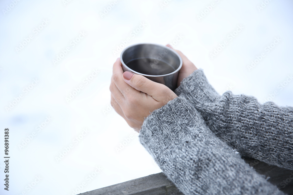 Hand holding coffee cup, outdoors