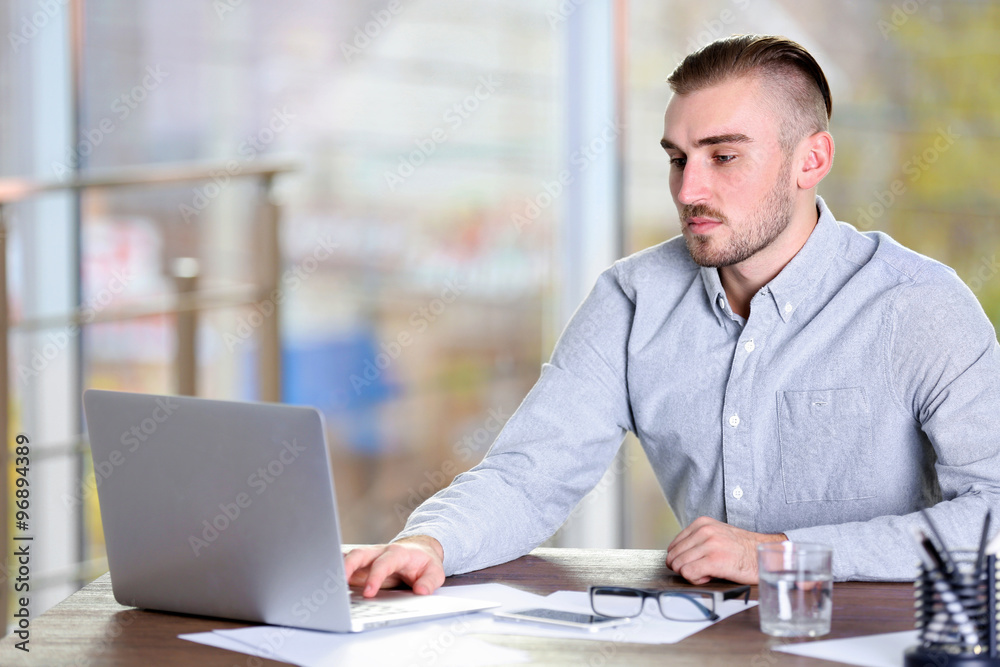 Businessman working with laptop in office