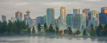 Vancouver Cityscape With Stanley Park / Looking South Towards The City Of Vancouver From Vancouver Harbour.  The Trees Are A Part Of Stanley Park.