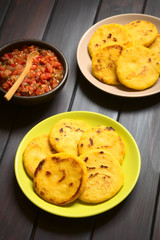 Poster - Colombian Arepa corn meal patties with hogao sauce (tomato and onion cooked) on the side (Selective Focus, Focus on the first arepas)