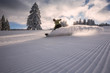 snowboarder on freshly groomed snow piste in Black Forest, Germany