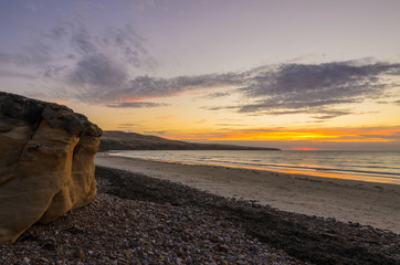 Wall Mural - Scenic coastline landscape at sunset with cliff boulders on the