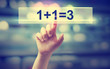© Tierney - 1+1=3 concept with hand pressing a button