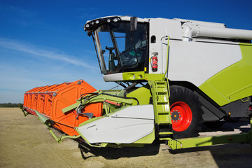 Poster - Combine harvester working on the field