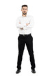 © sharplaninac - Young confident business man with crossed arms looking at camera. Full body length portrait isolated over white studio background.