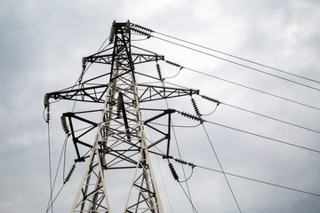 Wall Mural - Electricity pylon against cloudy sky