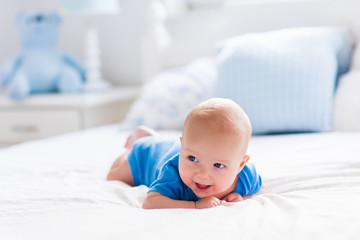 Wall Mural - baby boy in white sunny bedroom