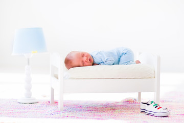 Wall Mural - little baby sleeping in toy bed