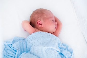 Wall Mural - cute newborn baby in white bed